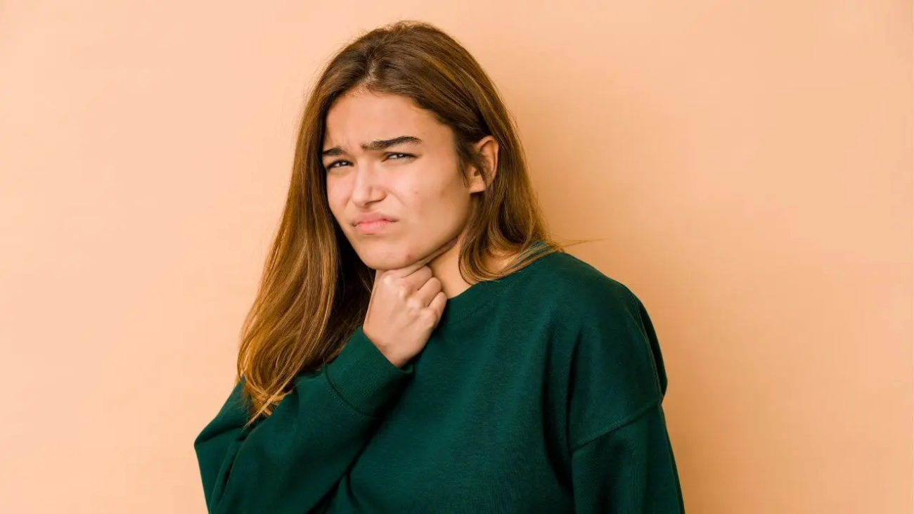 Vista de una mujer que padece de picor en la garganta